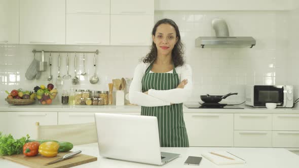 Portrait of happy smiling latin woman using a computer laptop notebook technology