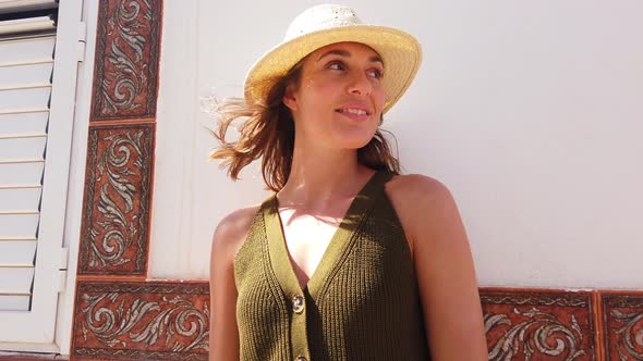 Beautiful Female Model in Straw Hat Looking Sideways on a Sunny Day