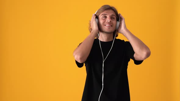 Happy blond man listening music