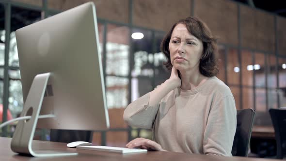 Old Woman with Neck Pain at Work