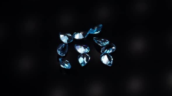 Natural Blue Topaz Gemstones on the Dark Background Turning Table