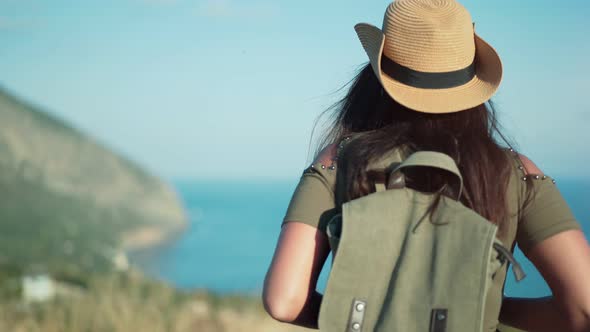 Rear View Backpacker Female Enjoying Travel Approaching to Beautiful Sea Surrounded By Mountains