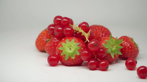 Delicious Red Juicy Strawberries And Cherries Rotating On The Turntable - Close Up Shot