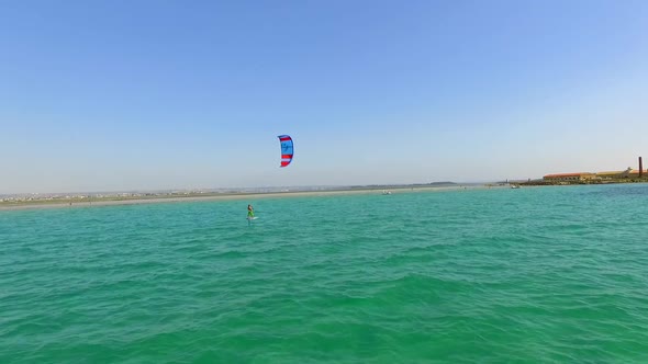 A man kiteboarding on a hydrofoil kite board.