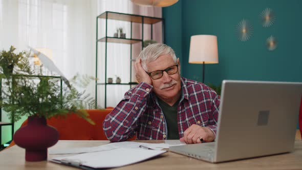 Grandfather Calculating Household Bills Bank Loan Online Domestic Expenditures Payment on Laptop App