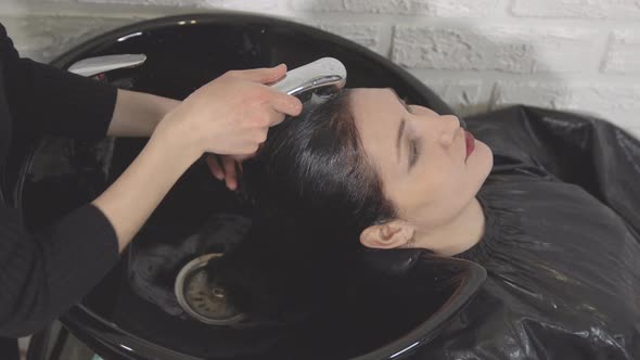 Young Woman in Beauty Salon. Washing Head