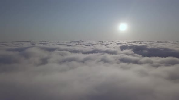 View From a Drone on a Sea of Clouds to the Horizon at Dawn