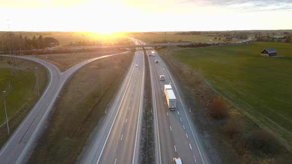 Aerial view of freeway intersection with moving traffic cars.