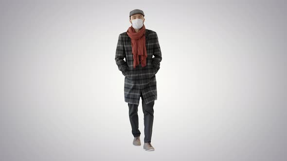 Gentleman with Medical Face Mask Walking on Gradient Background.