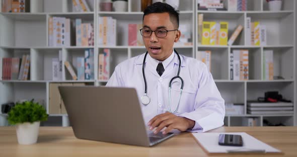 Doctor making conference call on laptop