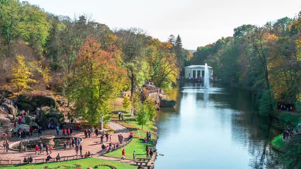 People Crowds Walking in Autumn Park in Time Lapse