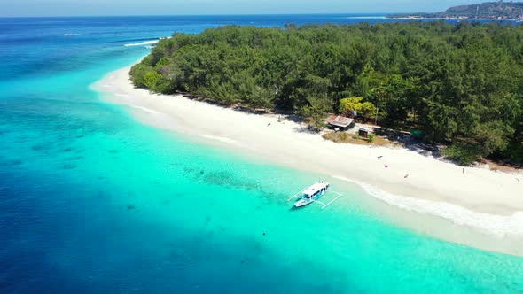 Colorful seascape with azure lagoon washing white sandy beach of tropical island with lush vegetatio