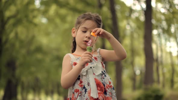 .Little Girl Blowing Soap Bubbles. Playful Cute Preschool Kid Leisure Outdoor Soap Bubble.