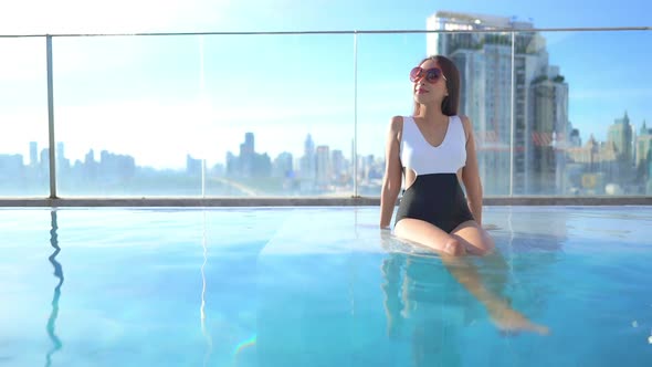 Young asian woman enjoy around outdoor swimming pool for leisure