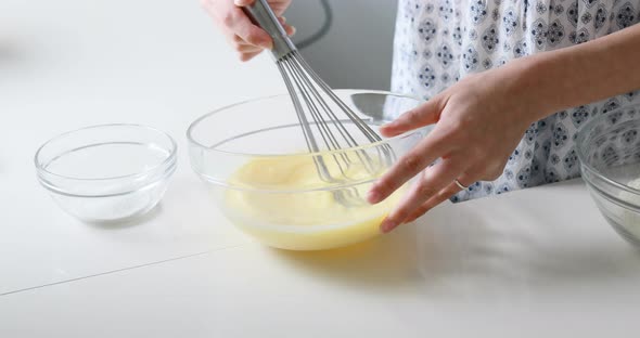 slender woman's hands work on the preparation of pancakes