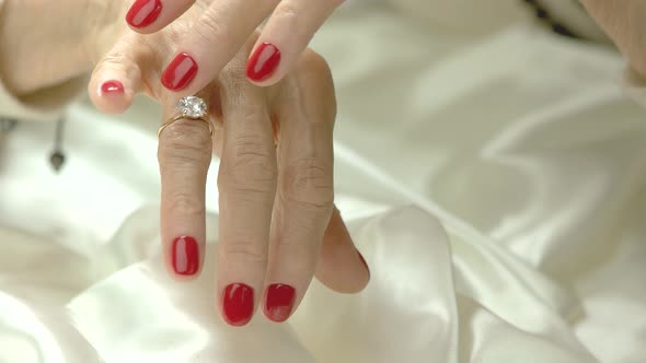 Ring with Stone on Female Manicured Hand.