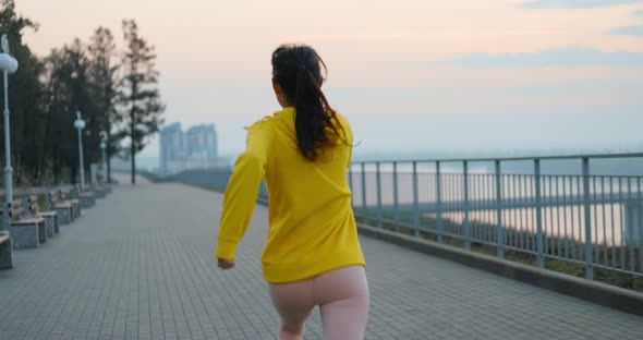 Young Woman Running In The Park