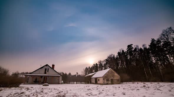 Winter Landscape with House in Forest Under Cloudy Sky