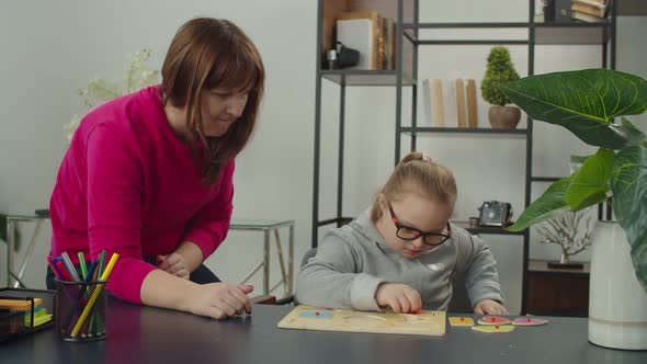 Kid with Special Needs Playing with Shape Sorter Toy