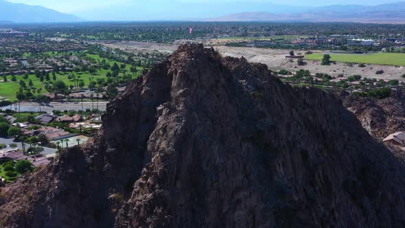 Aerial Drone Flyover of the American Flag on top of a Mountain