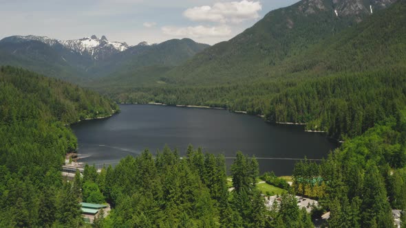 Aerial view of the scenic landscape around Capilano Lake and The Lions in North Vancouver, British C