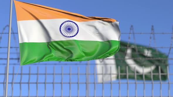 Flags of India and Pakistan Separated By Barbed Wire Fence