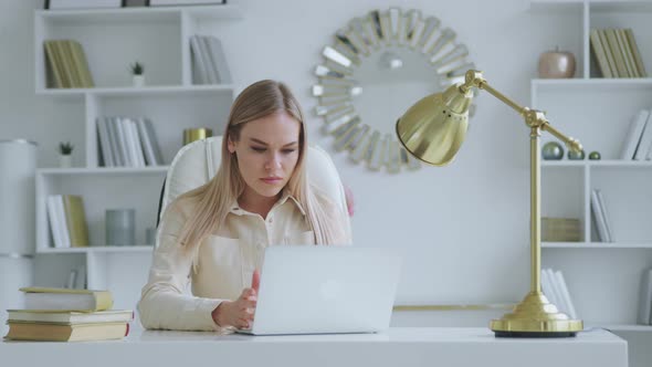 oung womale professional using computer at the desk at home