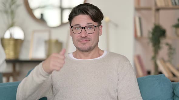 Middle Aged Man with Thumbs Up at Home