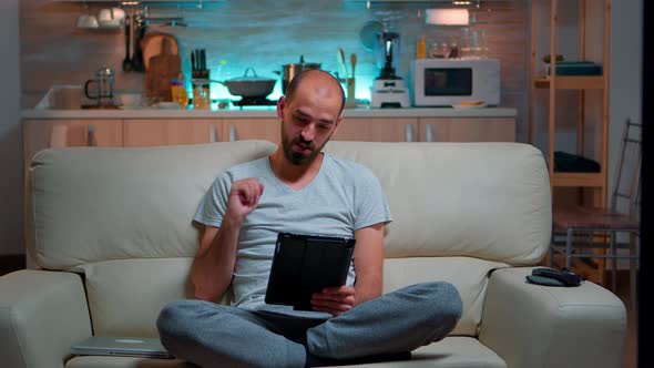 Focused Man Having Online Meeting Videocall on Tablet Computer