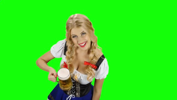 Girl in Bavarian Costume Drinking Beer From the Glass and Licked. Green Screen