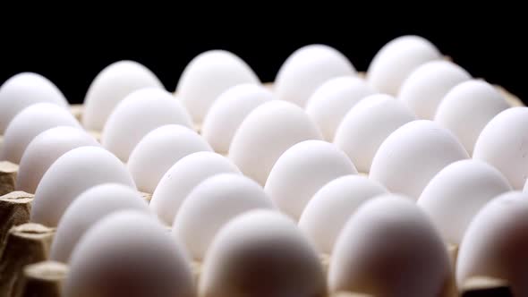 White chicken eggs in a cardboard box. Eggs in a paper tray.