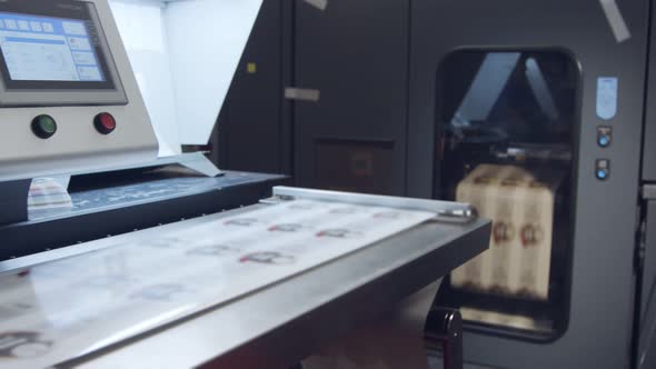 Large industrial digital printer printing sheets of paper