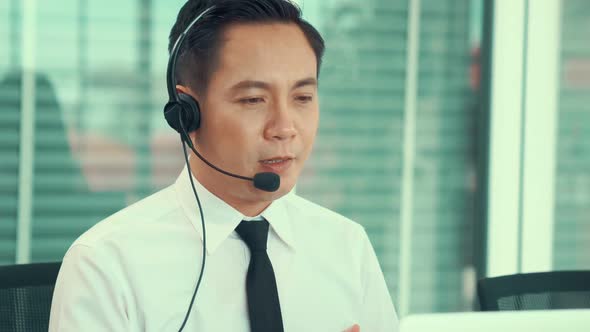 Businessman Wearing Headset Working Actively in Office