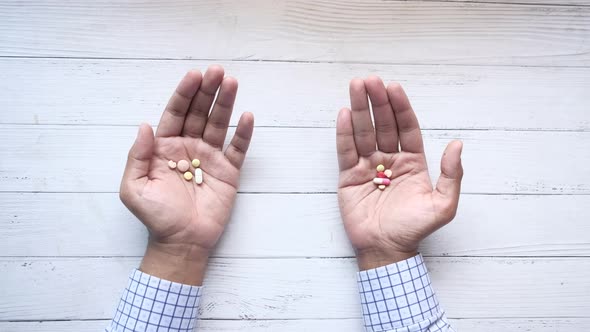 Top View of Many Medical Pills on Palm of Hand