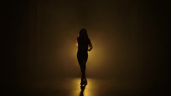 The Girl Dances and Professionally Performs Jazz Funk Elements in Slow Motion. Silhouettes on the