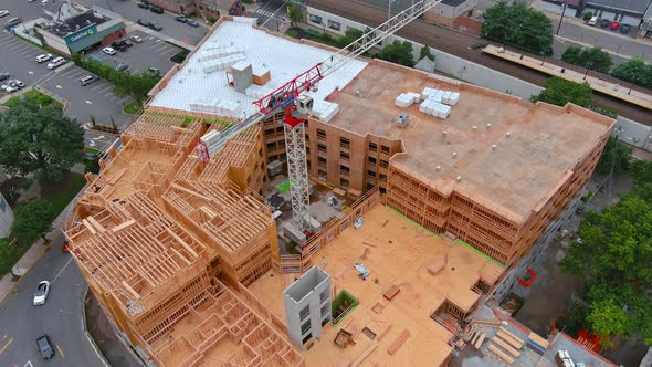 Aerial Top View with High Rise Building Under Construction at Tower Cranes