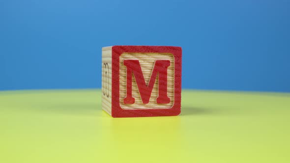 Close up shot letter "M" alphabet wooden block