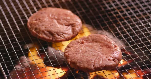 Burger on barbecue metal grill net