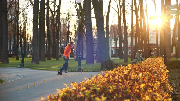 Professional Bearded Roller Conducts Daytime Training in an Autumn City Cozy Park, Makes Complex