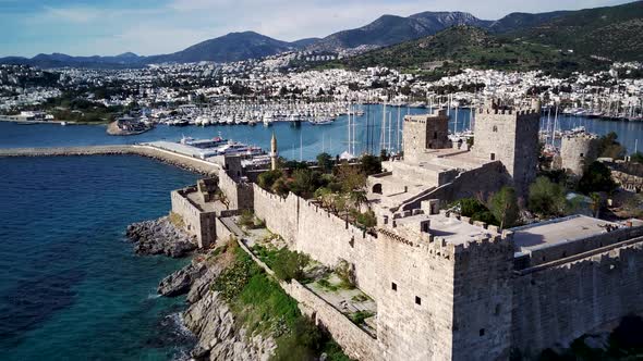 Amazing panoramic view from drone of full of yachts Bodrum harbour and ancient Kalesi castle.