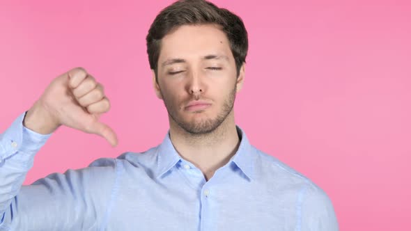 Thumbs Up By Young Man on Pink Background