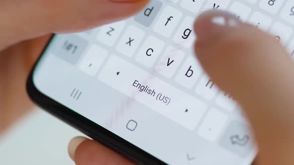 Hands Typing Text on Smartphone Close-up