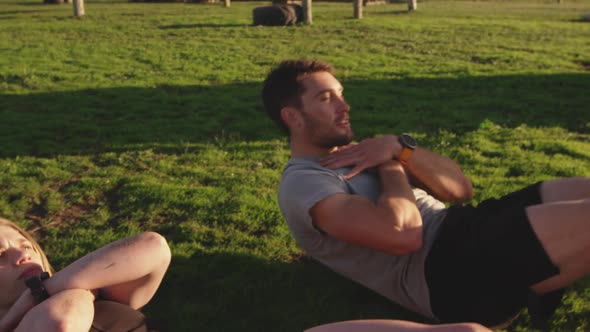 Young adults training at an outdoor gym bootcamp