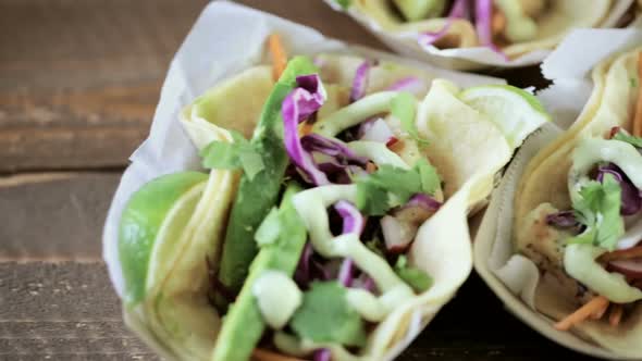 Street fish tacos with cod in recycled paper food tray.