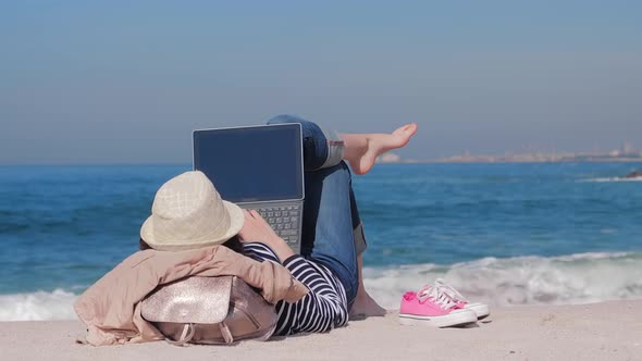 Woman Lying on Sandy Beach