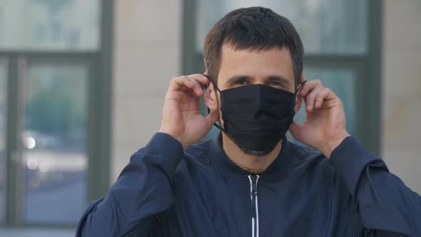 Man Puts on a Protective Mask