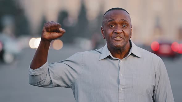 Confident Elderly Black Man Social Ethnic Male Activist Speak Outdoors Making Gesture Yes Holds Fist