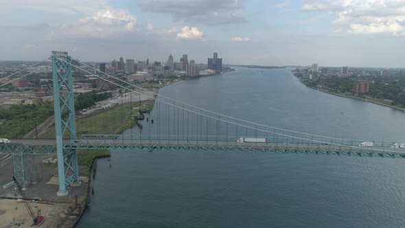 This video is about an aerial of the Ambassador Bridge over the Detroit river near downtown Detroit.