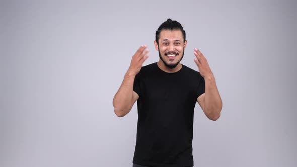 Happy and smiling Indian man inviting someone