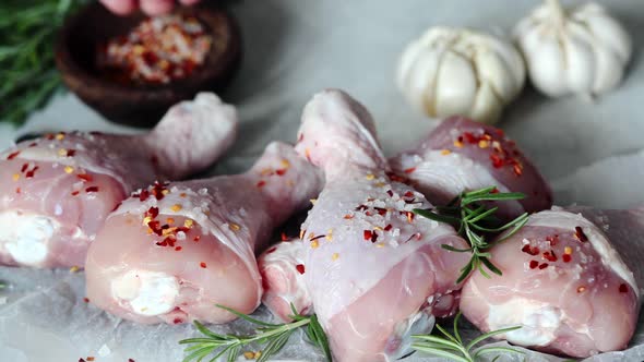 Cooking Chicken Legs with Spices, Garlic and Rosemary. Cooking Food Concept.